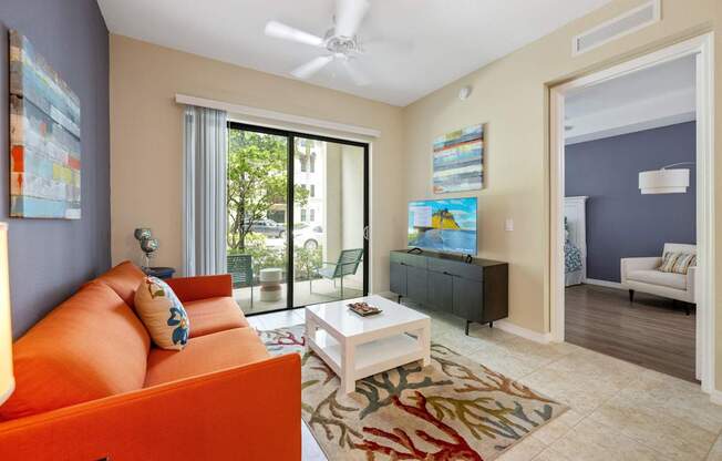 a living room with an orange couch and a coffee table