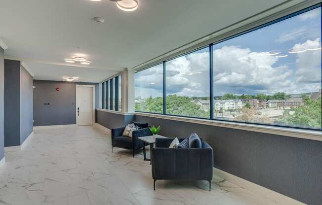 a lobby with couches and a window with a view of a city