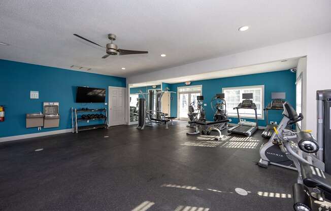 A spacious gym with a variety of exercise equipment.
