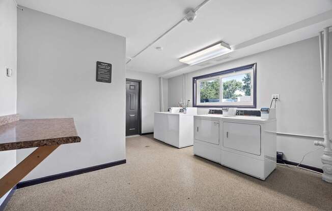 A white reception area with a desk and a window.
