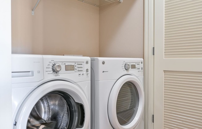 two washers and dryers in a laundry room