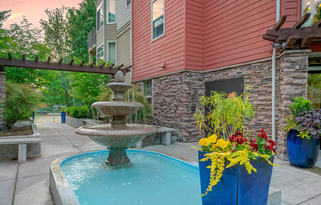 a fountain in front of a house with a swimming pool at Delano, Redmond, WA