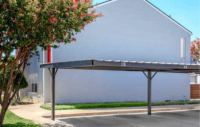 a covered parking lot in front of a building