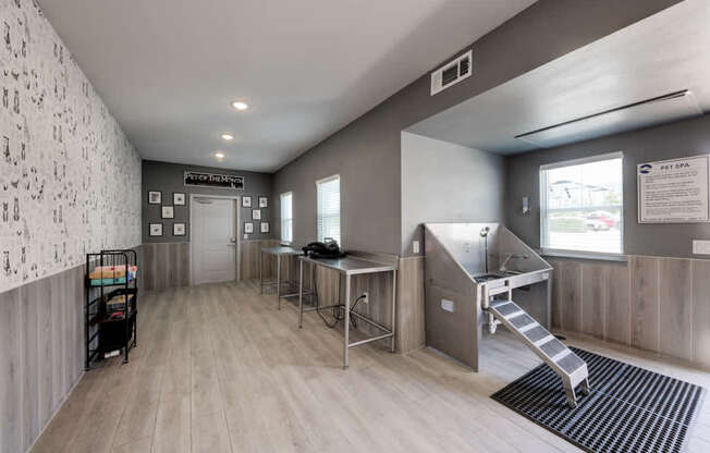 A hallway with a black and white patterned wall and a staircase.