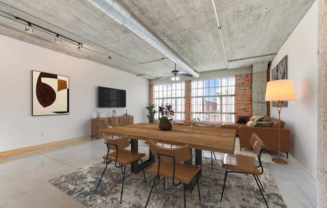 A dining room with a long wooden table and chairs.