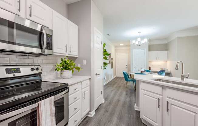 Summermill at Falls River Apartments Kitchen with white cabinets and stainless steel appliances