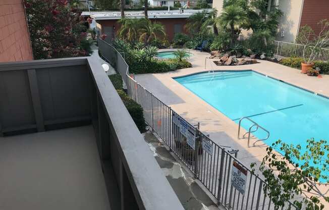 a view of the pool from the balcony of our apartment building