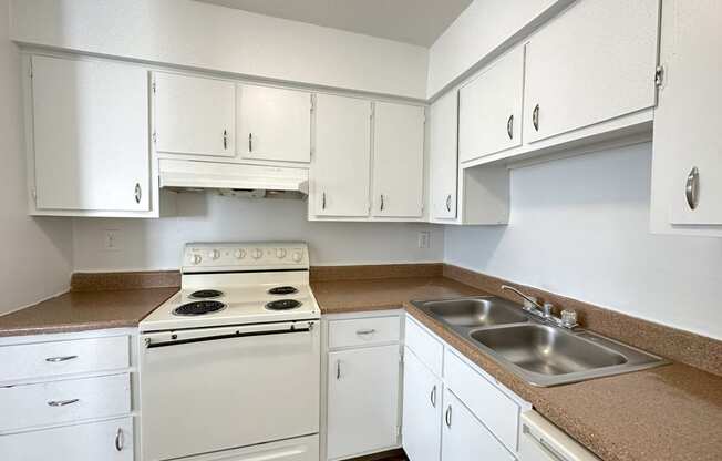 a kitchen with white cabinets and white appliances