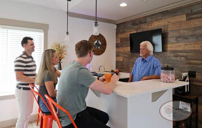 A group of people relaxing around the coffee bar.