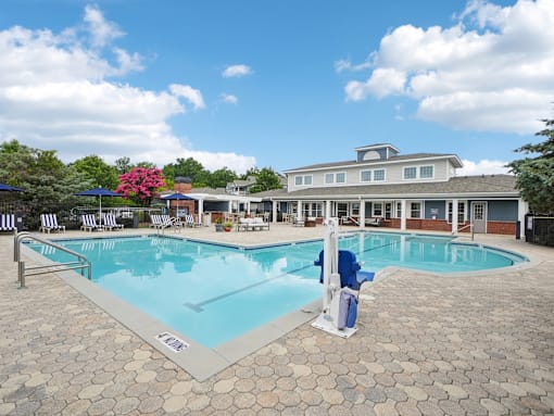 Resort-style swimming pool and outdoor lounge area at Village at Broadstone Station apartments in Apex, NC