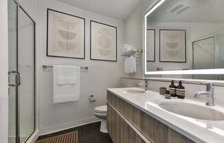 A bathroom with a white sink and a towel hanging on the wall.