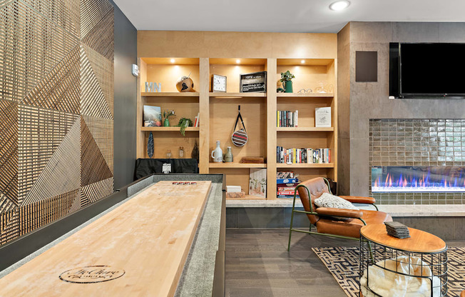 A modern living room with a fireplace and a shelving unit.