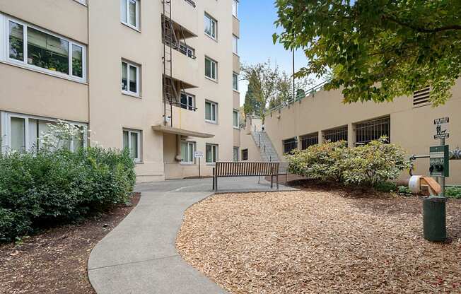 a park bench in front of an apartment building