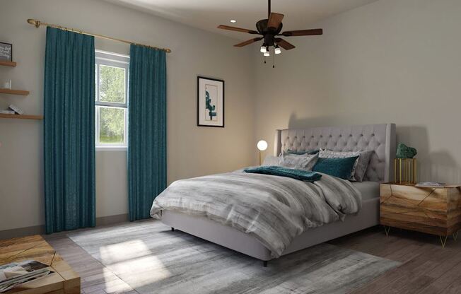 Cozy bedroom here at 49 West Apartments with a gray tufted bed, teal curtains, and wooden nightstands. A ceiling fan and sunlight create a calm, inviting atmosphere.