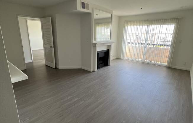 Living Room with Hardwood Floors, Fireplace and Patio Door