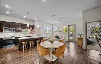 a living room with a kitchen and a dining table