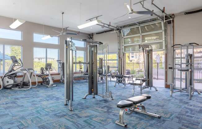 a gym with exercise equipment and windows