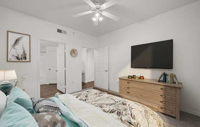 a bedroom with a bed and a ceiling fan