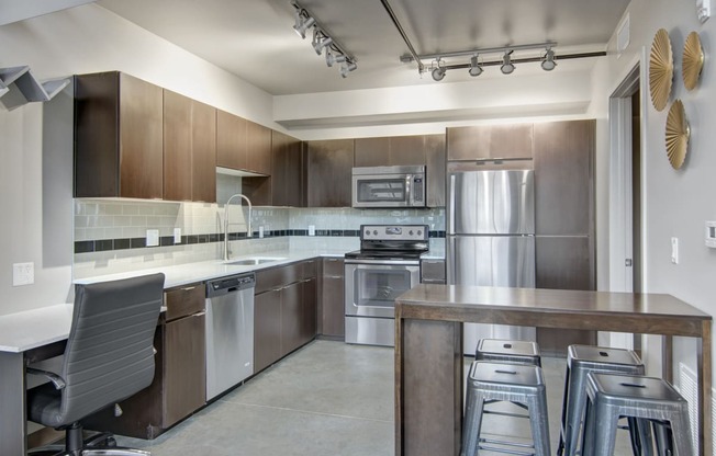 a kitchen with wooden cabinets and stainless steel appliances