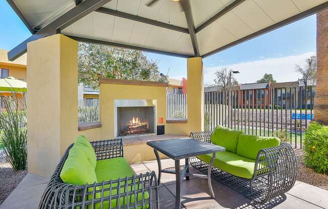 Outdoor fireplace and seating area under canopy at student apartments in Tempe, AZ