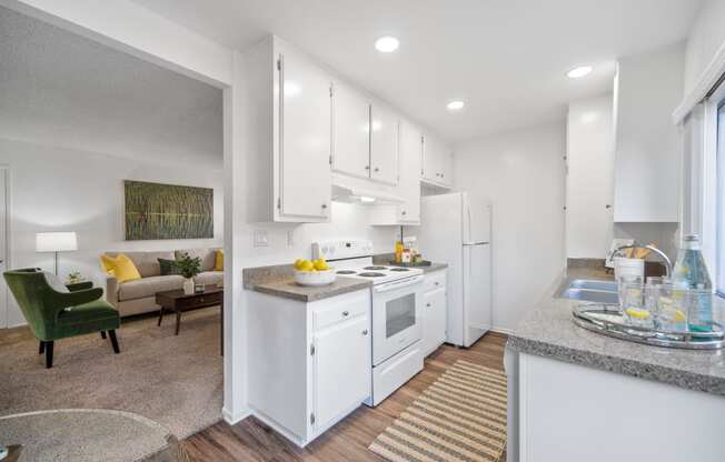 a white kitchen with white appliances and white cabinets
