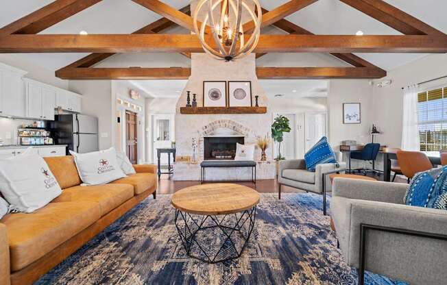 A living room with a fireplace and a large rug.