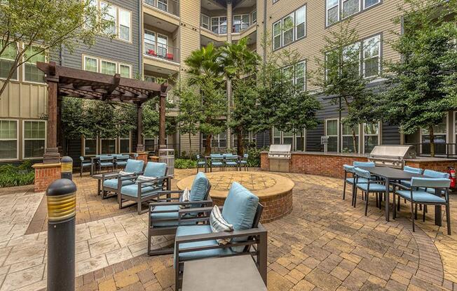 an outdoor patio area with chairs and tables and a fire pit