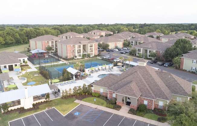 an aerial view of a neighborhood of houses and a swimming pool