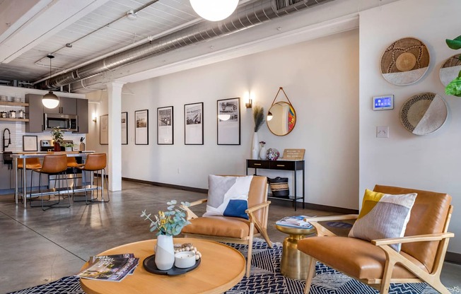 a living room with a couch and chairs and a table at Highland Mill Lofts, Charlotte, North Carolina