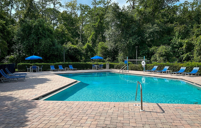 Enjoy a peaceful day at this serene poolside oasis, nestled within nature.