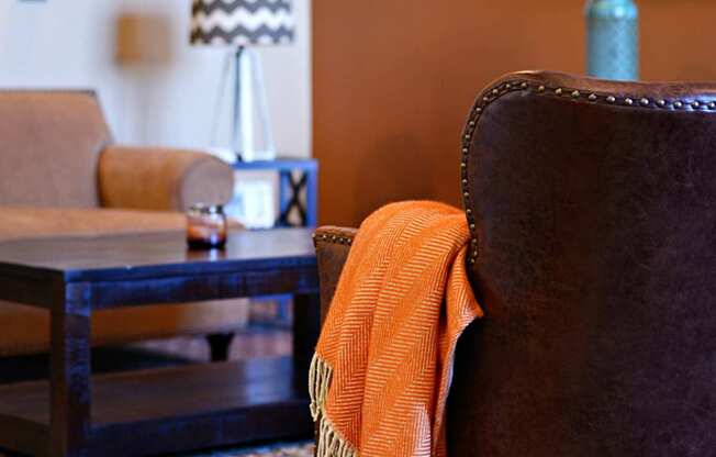 a living room with a brown chair and a television