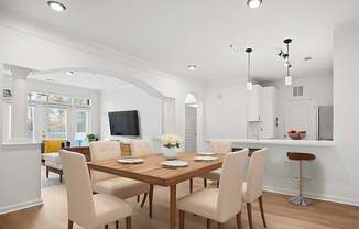A dining room with a wooden table and chairs.