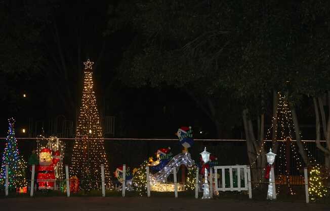A Christmas display with a large tree and a snowman.