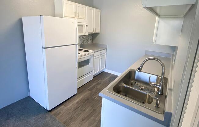 a kitchen with a stove top oven sitting inside of a refrigerator