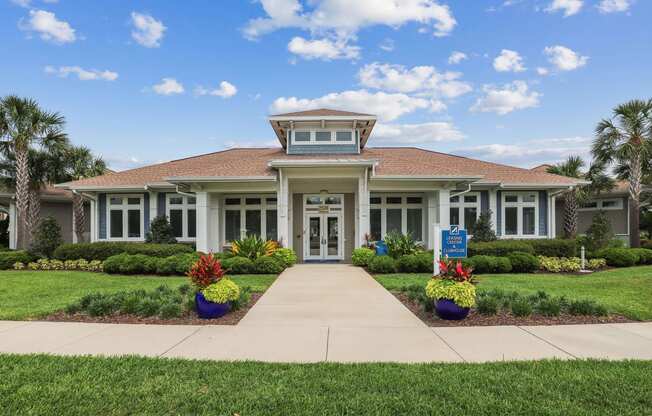 the front of a house with a walkway in front of it