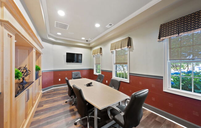 Fenwyck Manor's conference room with TV and conference tables and chairs