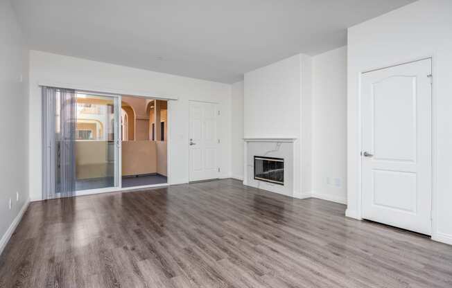 a bedroom with hardwood floors and white walls