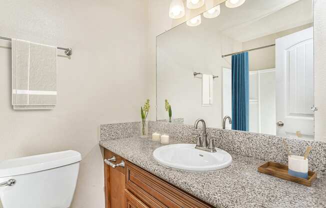 Apartment bathroom with towel rack, shower with tub and a large quartz countertop at Pacific Sands, San Diego, 92117