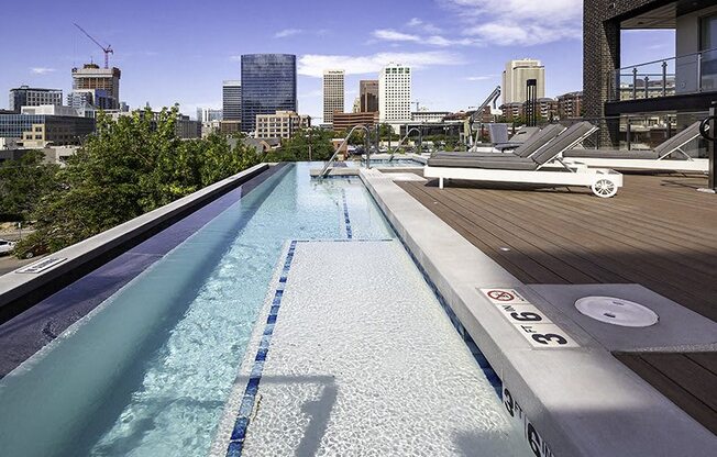 A rooftop pool with a city skyline in the background.