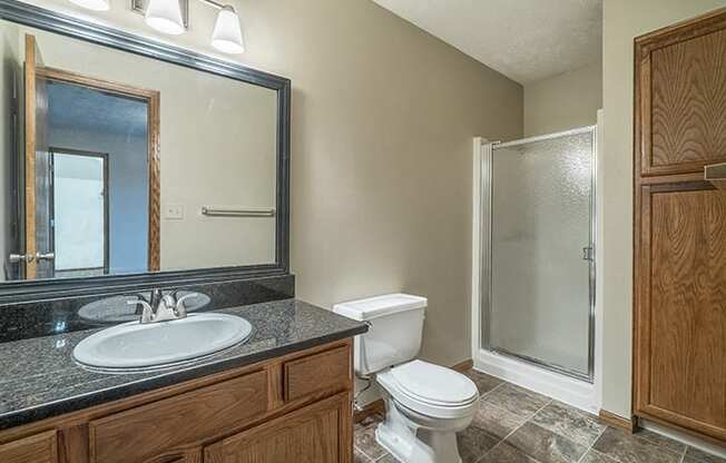 Full bathroom with shower and plenty of storage space at Fountain Glen Apartments