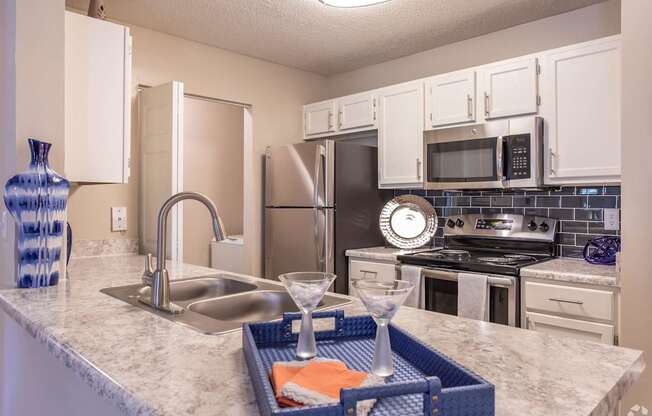 a kitchen with stainless steel appliances and granite counter tops