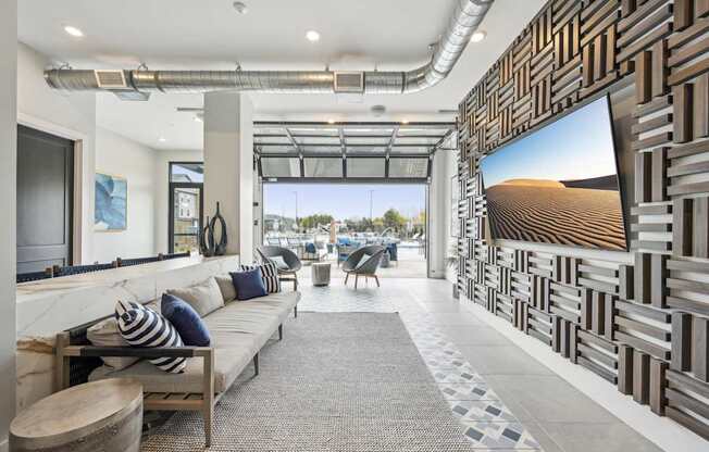a living room with a couch and a television at The Quarry Luxury Apartment Homes, Fort Collins, CO