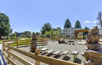 the preserve at ballantyne commons park with statues and a wooden fence