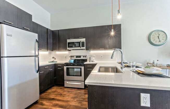 a kitchen with stainless steel appliances and white counter tops