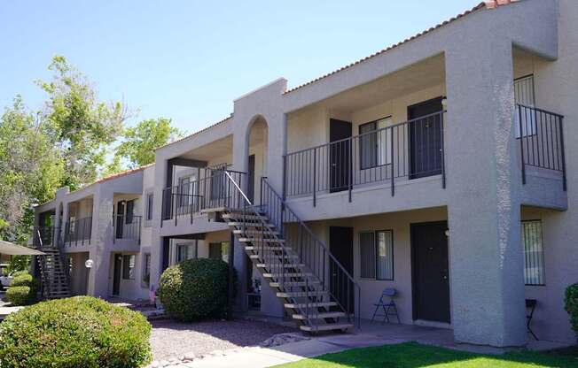 A building with a balcony and stairs leading to the second floor.