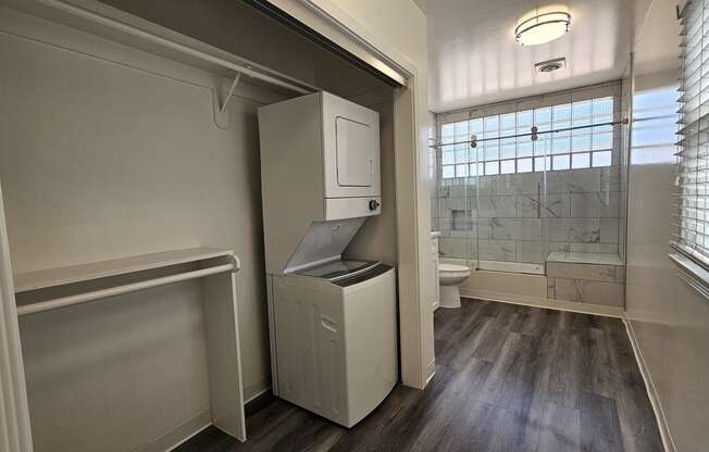 a small bathroom with a washer and dryer in it