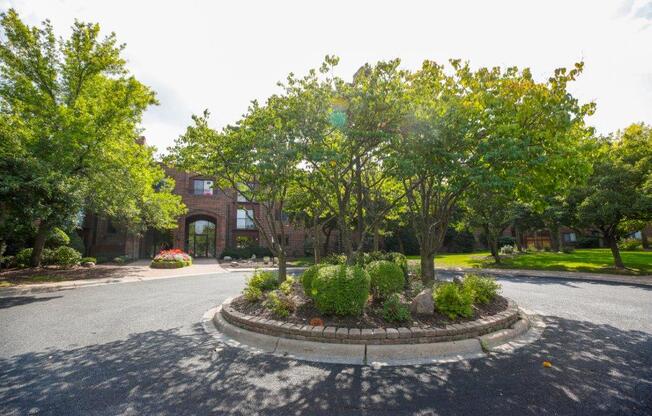 a red brick building with a roundabout in front of it