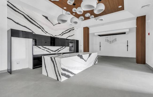 A modern kitchen with a black and white marble countertop. at The Franklin Marlboro Apartments, New Jersey