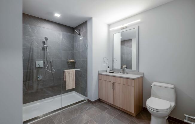 a bathroom with a toilet sink and shower