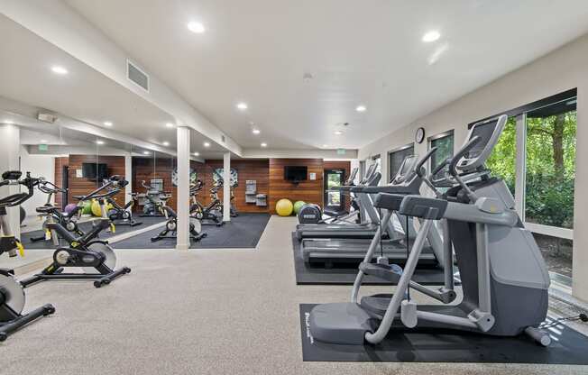 a gym with treadmills and other exercise equipment